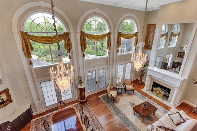 7023 Fair Oaks Dr, Export, PA 15632 - living room with a chandelier, a towering ceiling, healthy amount of natural light, and wood finished floors