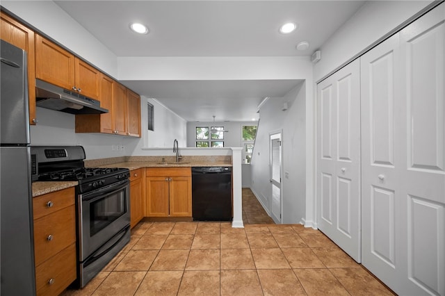 47 S 16th St, South Side, PA 15203 - kitchen with stainless steel appliances, under cabinet range hood, a peninsula, brown cabinets, and recessed lighting