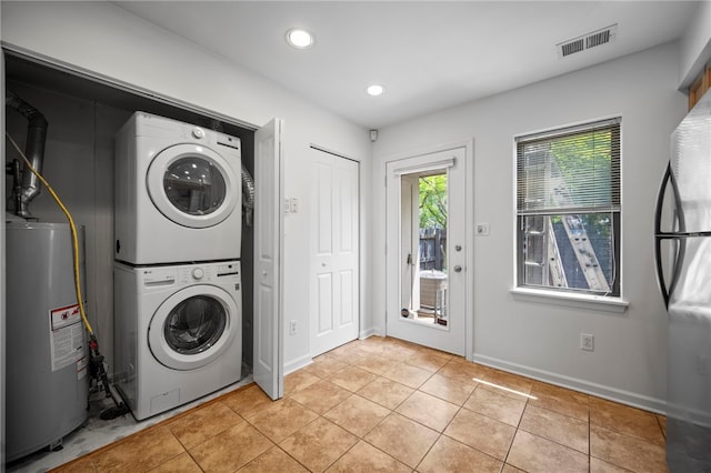 47 S 16th St, South Side, PA 15203 - laundry room with water heater, estacked washer and dryer, light tile patterned floors, and recessed lighting