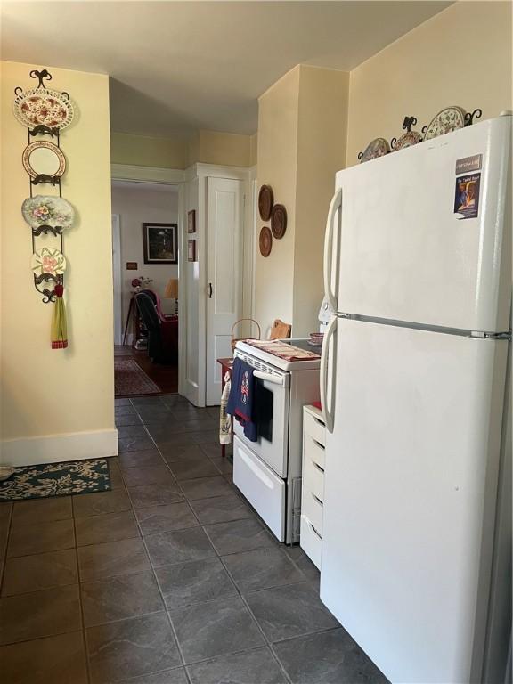766 6th St, Beaver, PA 15009 - kitchen featuring white appliances and dark tile patterned floors
