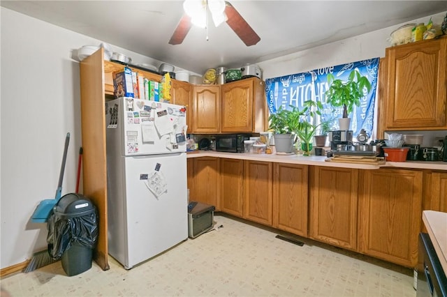 324 Linden Ave, Sharpsburg, PA 15215 - kitchen featuring freestanding refrigerator, brown cabinetry, black microwave, a ceiling fan, and light countertops