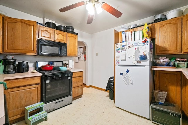 324 Linden Ave, Sharpsburg, PA 15215 - kitchen with black microwave, stainless steel range with gas cooktop, freestanding refrigerator, and light countertops