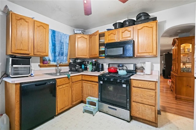 324 Linden Ave, Sharpsburg, PA 15215 - kitchen with black appliances, light countertops, arched walkways, and ceiling fan