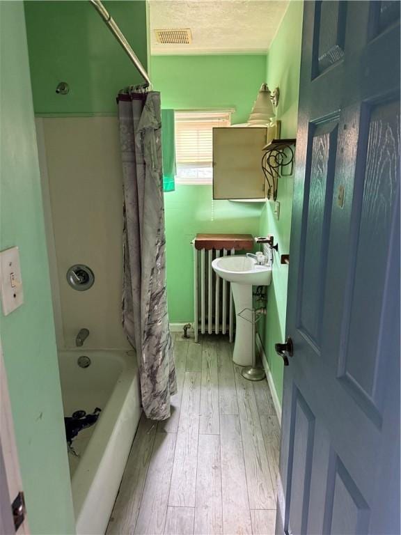 99 Mckean Ave, Donora, PA 15033 - bathroom featuring wood-type flooring and shower / tub combo