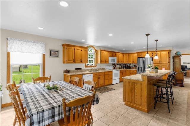 840 Sunol Rd, Deer Creek, PA 16314 - kitchen featuring white appliances, plenty of natural light, recessed lighting, a kitchen island, and light tile patterned floors