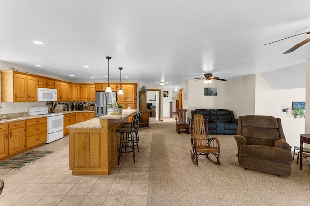 840 Sunol Rd, Deer Creek, PA 16314 - kitchen featuring white appliances, a ceiling fan, open floor plan, a breakfast bar, and recessed lighting