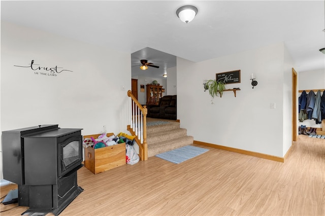 840 Sunol Rd, Deer Creek, PA 16314 - foyer entrance featuring a wood stove, light wood-type flooring, ceiling fan, and stairs