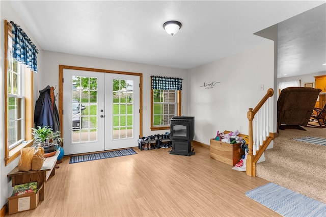 840 Sunol Rd, Deer Creek, PA 16314 - entryway featuring french doors, a wood stove, wood finished floors, and stairway