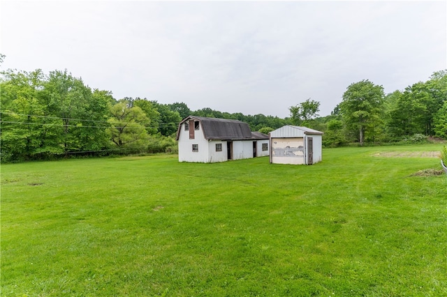 840 Sunol Rd, Deer Creek, PA 16314 - view of green lawn with an outdoor structure, a barn, and a detached garage