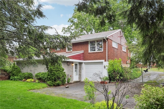 323 Dunbar Dr, Wilkins Twp, PA 15235 - view of front of property featuring asphalt driveway, a garage, and brick siding