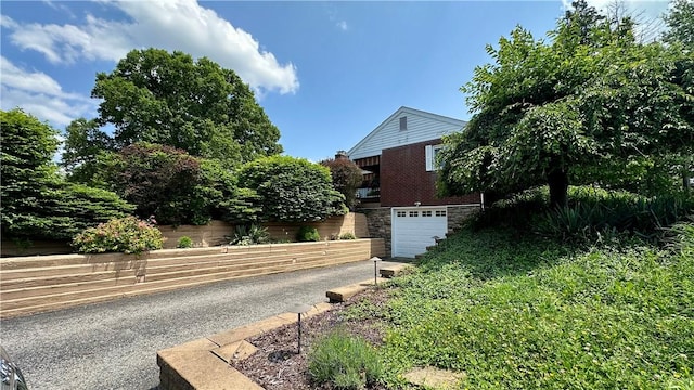 2231 Dellenbaugh Rd, Frazer, PA 15084 - view of property exterior with asphalt driveway, a garage, and brick siding
