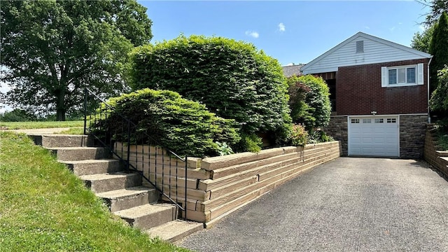 2231 Dellenbaugh Rd, Frazer, PA 15084 - view of property exterior with driveway, an attached garage, stairway, and brick siding