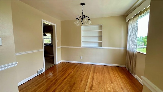 2231 Dellenbaugh Rd, Frazer, PA 15084 - unfurnished dining area with a chandelier, wood finished floors, and healthy amount of natural light