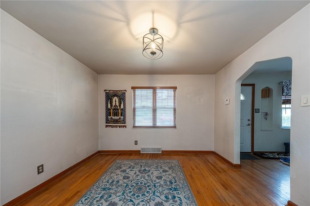 3037 Churchview, Baldwin Boro, PA 15227 - unfurnished room featuring healthy amount of natural light, arched walkways, and wood finished floors