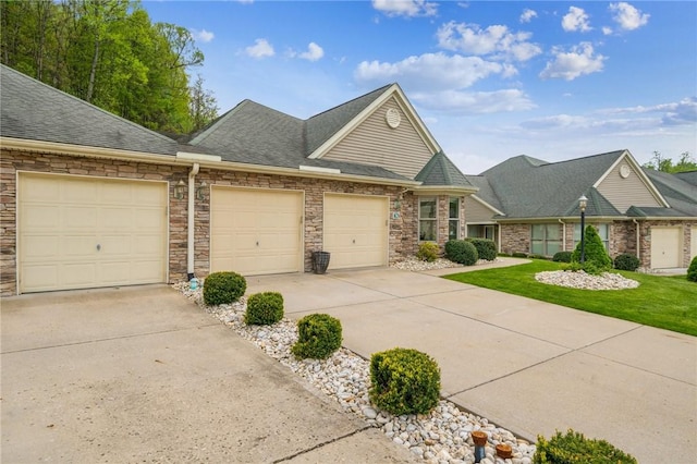 74 Quail Run, Unity Twp, PA 15601 - view of front of house featuring concrete driveway, a shingled roof, a garage, and stone siding