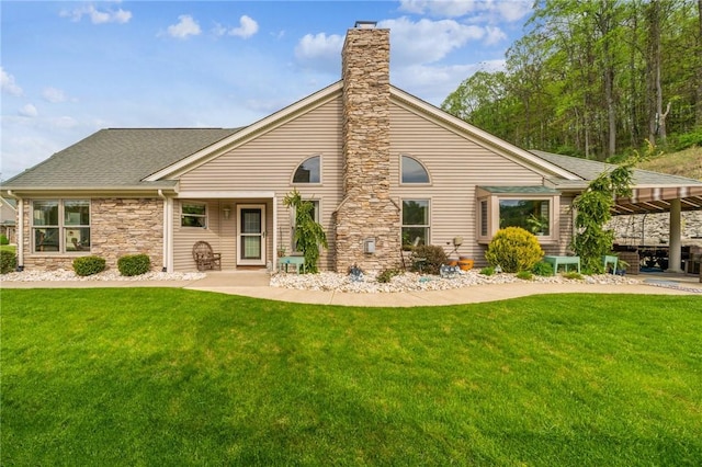 74 Quail Run, Unity Twp, PA 15601 - rear view of property featuring a chimney, a yard, stone siding, and a shingled roof