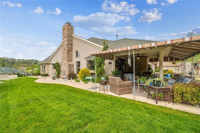 74 Quail Run, Unity Twp, PA 15601 - back of property featuring a patio, a lawn, outdoor lounge area, a chimney, and a ceiling fan