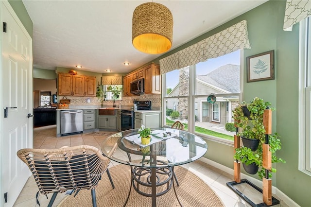 74 Quail Run, Unity Twp, PA 15601 - kitchen with appliances with stainless steel finishes, brown cabinets, light countertops, light tile patterned flooring, and recessed lighting