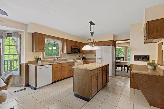 403 Lundy Ct, Cranberry Twp, PA 16066 - kitchen with white appliances, a kitchen island, brown cabinets, light countertops, and light tile patterned floors