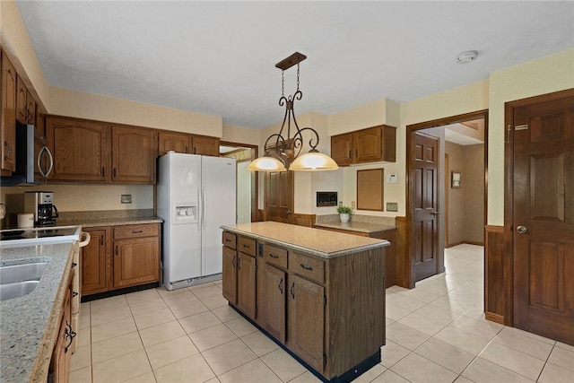 403 Lundy Ct, Cranberry Twp, PA 16066 - kitchen featuring white refrigerator with ice dispenser, stainless steel microwave, light tile patterned flooring, a kitchen island, and hanging light fixtures