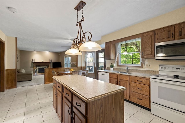 403 Lundy Ct, Cranberry Twp, PA 16066 - kitchen with white appliances, a kitchen island, light countertops, a fireplace with raised hearth, and pendant lighting
