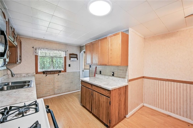 816 Wheatland Rd, Shenango Twp Mer, PA 16159 - kitchen with light wood-style floors, range with gas cooktop, light countertops, arched walkways, and a wainscoted wall