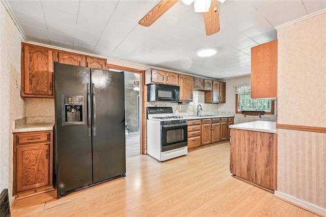 816 Wheatland Rd, Shenango Twp Mer, PA 16159 - kitchen featuring black appliances, light countertops, light wood finished floors, a ceiling fan, and tasteful backsplash