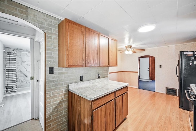 816 Wheatland Rd, Shenango Twp Mer, PA 16159 - kitchen featuring arched walkways, light wood-style floors, a ceiling fan, brown cabinets, and stove