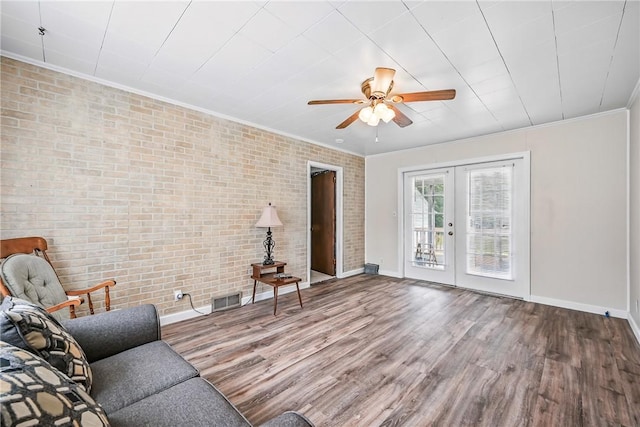 816 Wheatland Rd, Shenango Twp Mer, PA 16159 - living room with ornamental molding, brick wall, wood finished floors, a ceiling fan, and french doors