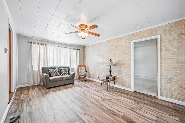 816 Wheatland Rd, Shenango Twp Mer, PA 16159 - sitting room with a ceiling fan, crown molding, wood finished floors, and brick wall