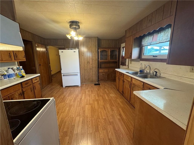 2193 Springhill Furnace Rd, Springhill Twp, PA 15478 - kitchen featuring white appliances, exhaust hood, brown cabinets, light wood-style flooring, and wood walls
