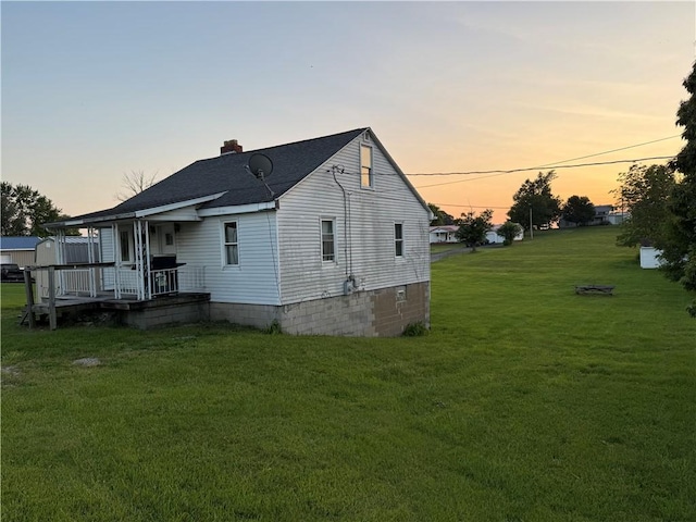 2193 Springhill Furnace Rd, Springhill Twp, PA 15478 - view of side of property featuring a porch, a lawn, a chimney, and roof with shingles