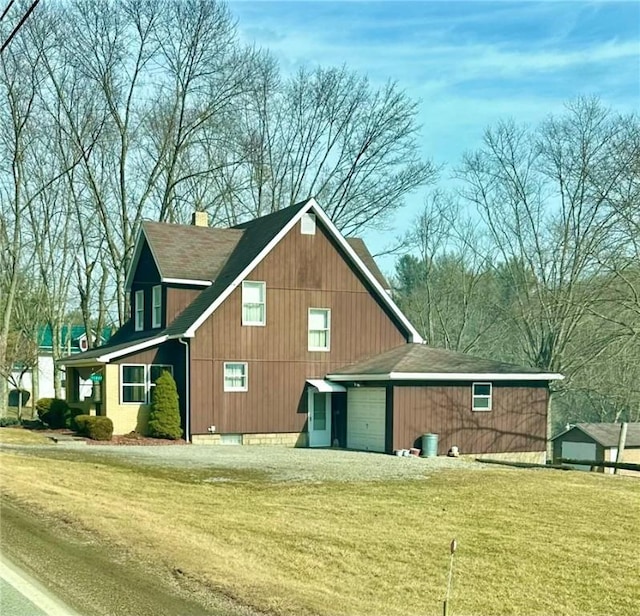 11637 State Route 85, Rayburn Twp, PA 16201 - view of side of home featuring an attached garage, a chimney, a lawn, and driveway