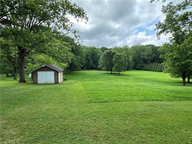 11637 State Route 85, Rayburn Twp, PA 16201 - view of green lawn featuring a storage unit and a detached garage