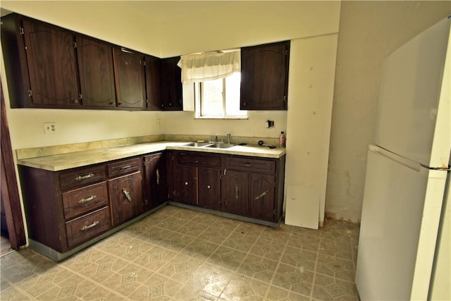 140 Saint Joseph St, Mount Oliver, PA 15210 - kitchen featuring freestanding refrigerator, light countertops, and dark brown cabinetry