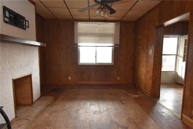 140 Saint Joseph St, Mount Oliver, PA 15210 - unfurnished living room featuring ceiling fan, hardwood / wood-style flooring, a paneled ceiling, healthy amount of natural light, and wooden walls