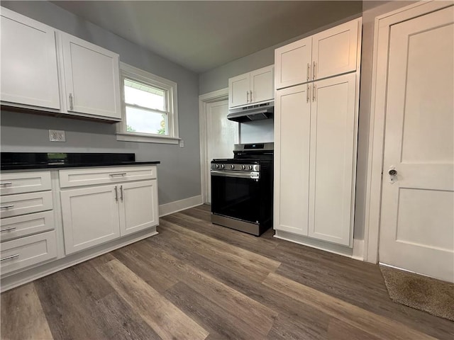 4352 Ellwood Rd, Wayne Twp Law, PA 16101 - kitchen with stainless steel range with gas stovetop, under cabinet range hood, white cabinets, dark wood-style flooring, and dark countertops