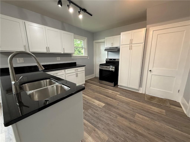 4352 Ellwood Rd, Wayne Twp Law, PA 16101 - kitchen featuring stainless steel range with gas stovetop, dark countertops, white cabinetry, and dark wood finished floors
