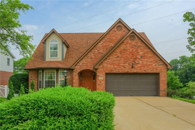 135 Jarod Dr, Moon/Crescent Twp, PA 15108 - view of front of home with brick siding, roof with shingles, an attached garage, and concrete driveway