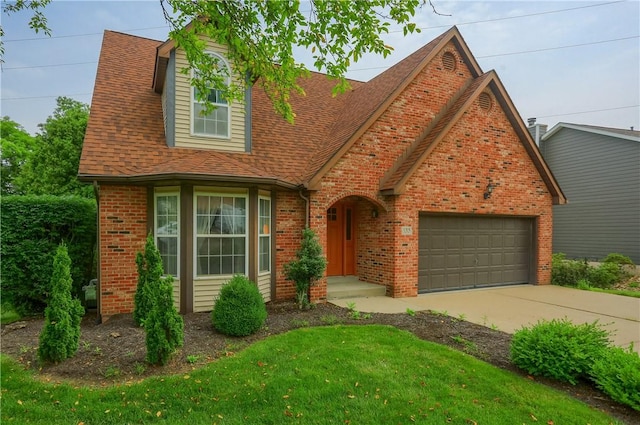 135 Jarod Dr, Moon/Crescent Twp, PA 15108 - view of front of house with a garage, brick siding, driveway, a shingled roof, and a front lawn