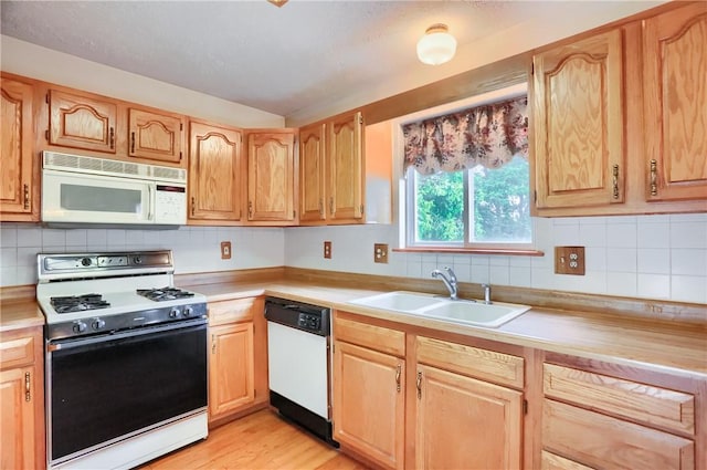 135 Jarod Dr, Moon/Crescent Twp, PA 15108 - kitchen with white appliances, light countertops, tasteful backsplash, light wood-style floors, and light brown cabinets