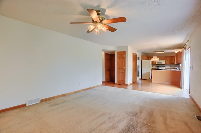 135 Jarod Dr, Moon/Crescent Twp, PA 15108 - unfurnished living room featuring light colored carpet and a ceiling fan