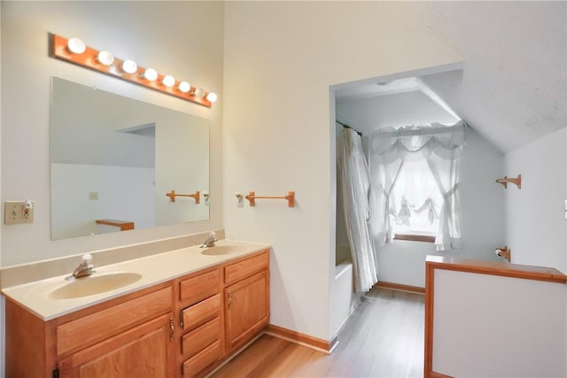 135 Jarod Dr, Moon/Crescent Twp, PA 15108 - bathroom with wood finished floors, double vanity, shower / bath combo, and lofted ceiling
