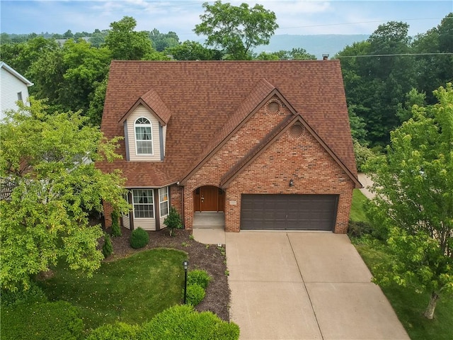 135 Jarod Dr, Moon/Crescent Twp, PA 15108 - view of front of property featuring brick siding, an attached garage, driveway, and roof with shingles