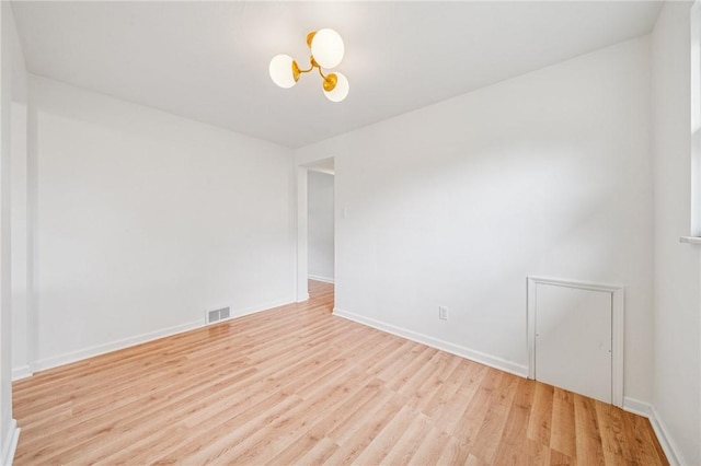 4154 Steiger St, Castle Shannon, PA 15234 - empty room with a chandelier and light wood-style floors