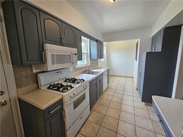619 Ridge Ave, New Kensington, PA 15068 - kitchen featuring white appliances, decorative backsplash, light countertops, and light tile patterned flooring