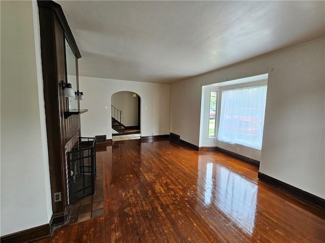 619 Ridge Ave, New Kensington, PA 15068 - unfurnished living room with arched walkways, wood-type flooring, and stairway