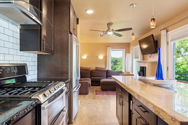548 Penn St, Verona, PA 15147 - kitchen with appliances with stainless steel finishes, wall chimney exhaust hood, decorative backsplash, light stone counters, and dark brown cabinets