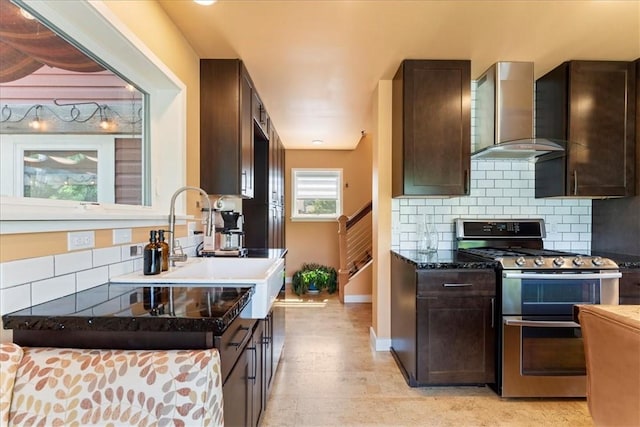 548 Penn St, Verona, PA 15147 - kitchen featuring double oven range, wall chimney exhaust hood, dark brown cabinetry, tasteful backsplash, and light wood-type flooring