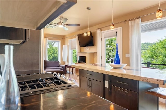 548 Penn St, Verona, PA 15147 - kitchen with plenty of natural light, ceiling fan, light stone counters, and open floor plan